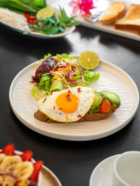 Tostada de aguacate con huevo y ensalada, del desayuno del Belhamy